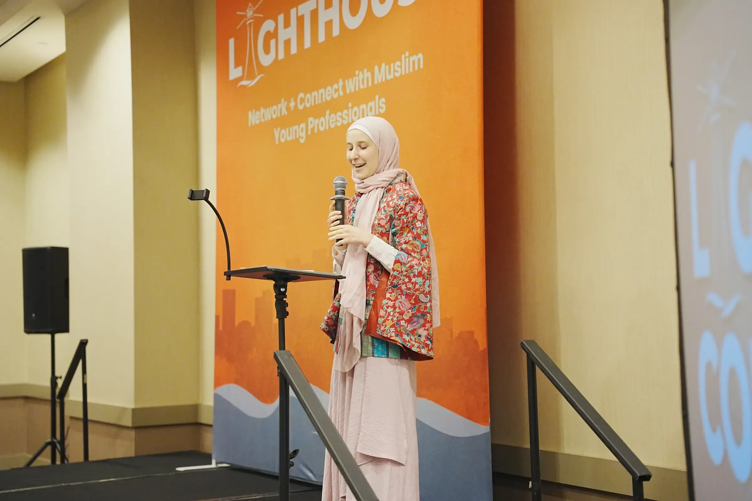 A speaker presenting from the podium at the 2025 Lighthouse Conference